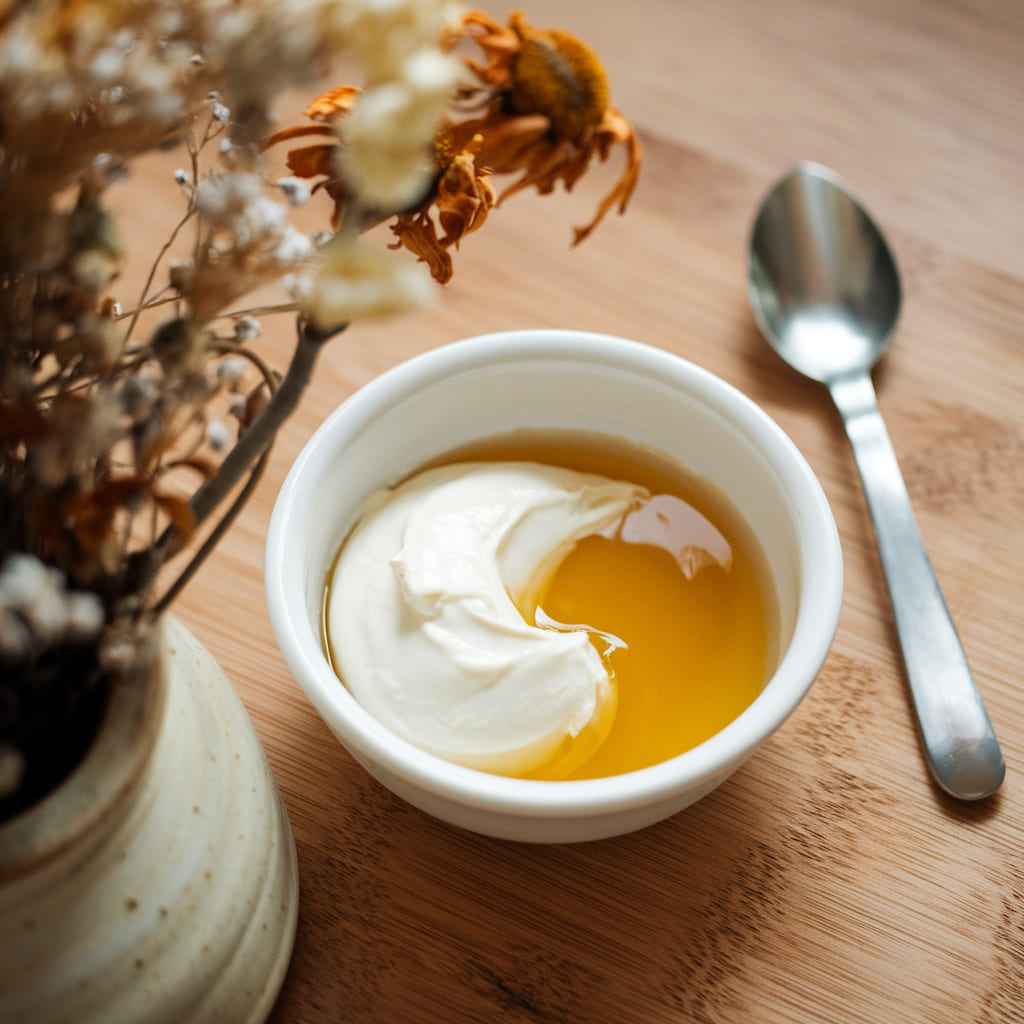 In a world overflowing with expensive serums and chemically loaded creams, sometimes the best skincare solution is hiding right in the kitchen. Curd deserves serious consideration as one of the most powerful, all-natural beauty remedies around.

Whether the concern is dryness, acne, pigmentation, or dull skin, using curd for skincare can transform complexion, leaving it soft, bright, and youthful.

Here's a closer look at the amazing benefits of curd for skincare, the best DIY treatments, and expert tips for working this natural wonder into a beauty routine.

Table of Contents
#1. Why Using Curd for Skincare is a Must for Every Skin Type

Curd isn't just a delicious snack, it's also one of the most effective natural ingredients for skincare. Whether skin is oily, dry, sensitive, or acne-prone, curd's gentle yet powerful properties make it a good fit for everyone.

Provides Deep Hydration for Soft, Supple Skin

For dry, flaky skin, curd is the perfect natural moisturizer. The healthy fats, proteins, and enzymes in curd help lock in moisture, leaving skin plump and well-hydrated without clogging pores.

Brightens Skin and Fades Pigmentation

For uneven skin tone and dark spots, the lactic acid in curd acts as a mild exfoliant, gently removing dead skin cells and revealing brighter, glowing skin.

With regular use, curd fades pigmentation, acne scars, and sunspots, contributing to a more even complexion.

Controls Acne and Excess Oil Production

Curd is a lifesaver for acne-prone and oily skin. Its zinc and probiotic content help regulate oil production, fight acne-causing bacteria, and calm inflamed skin. It also helps prevent future breakouts while keeping skin fresh and matte.

Fights Wrinkles and Slows Down Aging

For fine lines and sagging skin, using curd for skincare helps stimulate collagen production, keeping skin firm and elastic. The antioxidants in curd fight free radicals, helping prevent premature aging and reducing the appearance of wrinkles.

Reduces Dark Circles and Puffy Eyes

The lactic acid and probiotics in curd work wonders for reducing puffiness and lightening dark circles, leaving eyes looking well-rested and refreshed. A little dabbed under the eyes makes for a quick skin pick-me-up.

#2. Using Curd for Skincare with Easy DIY Remedies for Every Skin Concern

With the benefits of curd for skincare covered, here are some of the best DIY treatments to give skin the love it deserves.

Curd and Honey Glow-Boosting Face Mask

This mask is perfect for dry and dull skin, delivering an instant glow and hydration boost.

Ingredients:

2 tablespoons curd
1 teaspoon raw honey
½ teaspoon lemon juice (optional for extra brightness)

Instructions:

Mix all ingredients into a smooth paste.

Apply evenly to the face and leave for 15 minutes.

Rinse with lukewarm water and pat dry.

Use twice a week for glowing, hydrated skin.

Curd and Turmeric Anti-Acne Face Pack

This powerful anti-inflammatory face pack helps clear breakouts, reduce redness, and control excess oil.

Ingredients:

2 tablespoons curd
½ teaspoon turmeric
1 teaspoon sandalwood powder (optional for extra acne-fighting benefits)

Instructions:

Mix all ingredients into a thick paste.

Apply to acne-prone areas and leave for 15 to 20 minutes.

Rinse with cold water and moisturize as usual.

Use twice a week to keep acne away.

Curd and Oatmeal Exfoliating Scrub

This gentle scrub removes dead skin cells, revealing fresh, smooth skin.

Ingredients:

2 tablespoons curd
1 tablespoon oatmeal (ground)
½ teaspoon honey

Instructions:

Mix ingredients and apply to damp skin.

Gently massage in circular motions for 2 to 3 minutes.

Rinse with warm water and enjoy soft, refreshed skin.

Use twice a week for best results.

Curd and Aloe Vera Sunburn Soothing Mask

Perfect for sunburned and irritated skin, this cooling mask provides instant relief.

Ingredients:

2 tablespoons chilled curd
1 tablespoon aloe vera gel
1 teaspoon cucumber juice

Instructions:

Mix ingredients and apply to affected areas.

Leave on for 20 minutes, then rinse with cool water.

Use as needed to soothe and heal sunburn.

#3. Other Beauty Benefits of Using Curd for Skincare

Curd isn't just for the face, it's also great for full-body beauty treatments.

Softens rough elbows and knees: Apply curd mixed with lemon juice for softer skin.

Reduces scalp dandruff: Massage curd onto the scalp for a natural dandruff remedy.

Hydrates dry hands and feet: Use curd as a hand and foot mask for deep nourishment.

Brightens underarms: Lightens dark underarms when used regularly with turmeric.

#4. Disclaimer

This article is for informational purposes only. For sensitive skin, a patch test before applying curd is recommended. Consulting a dermatologist is advised if irritation occurs.

